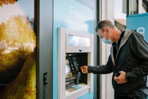 man using atm machine