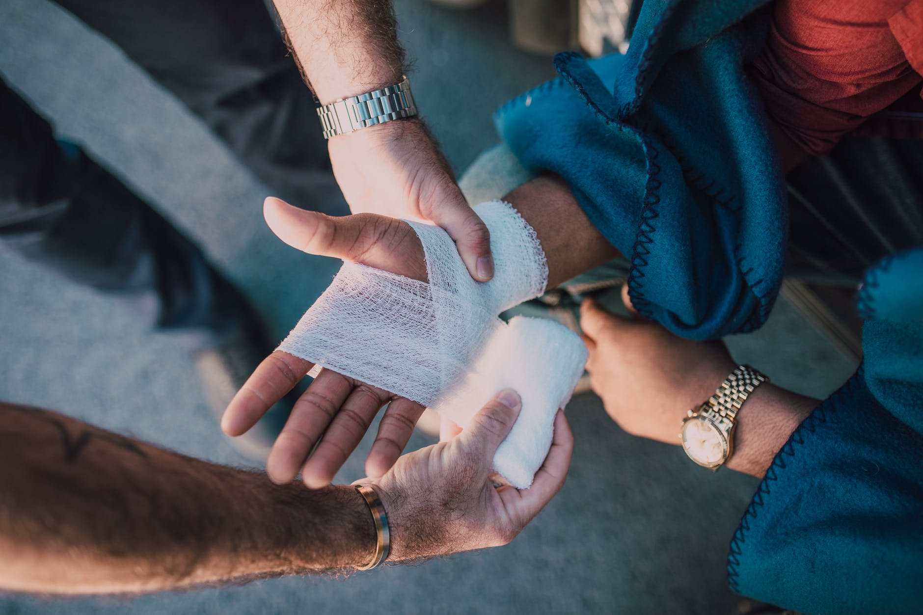 person applying bandage on another person s hand