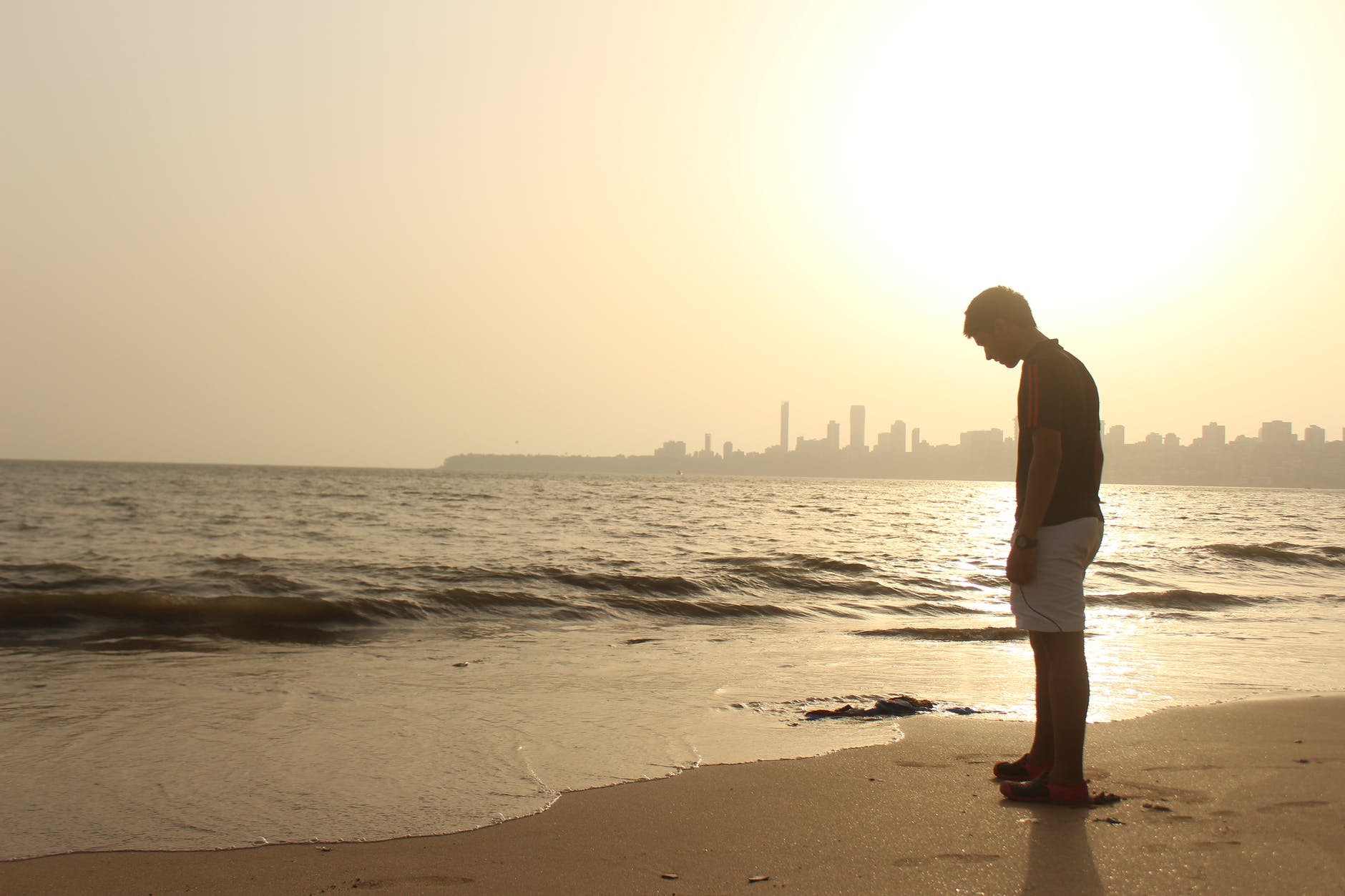 man standing on seashore