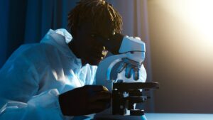 a man looking through the microscope