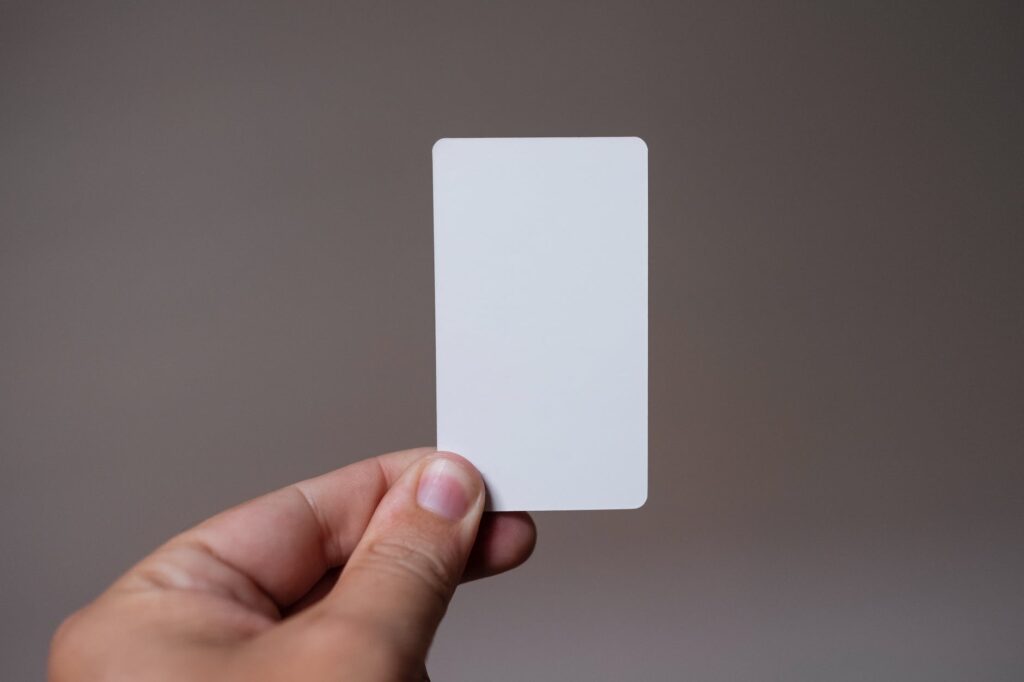 person holding white rectangular card