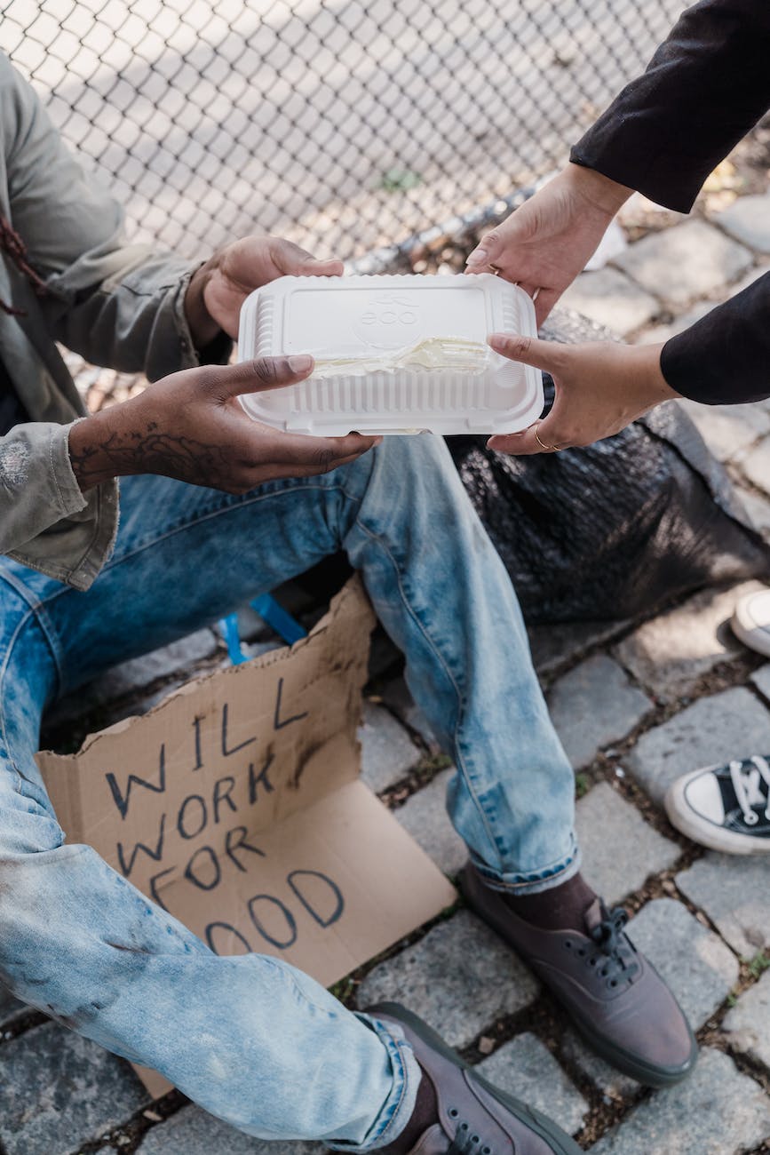 person giving alms to the poor