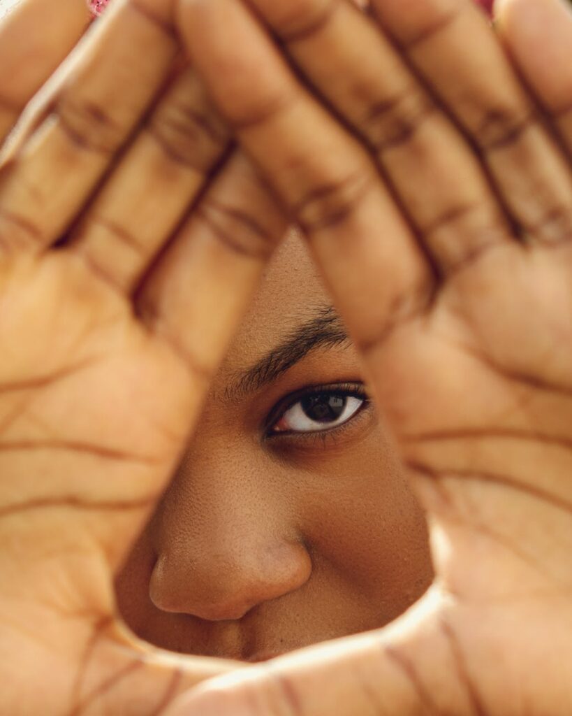 person covering their face with hands