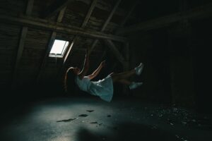 woman in white dress falling on gray concrete floor