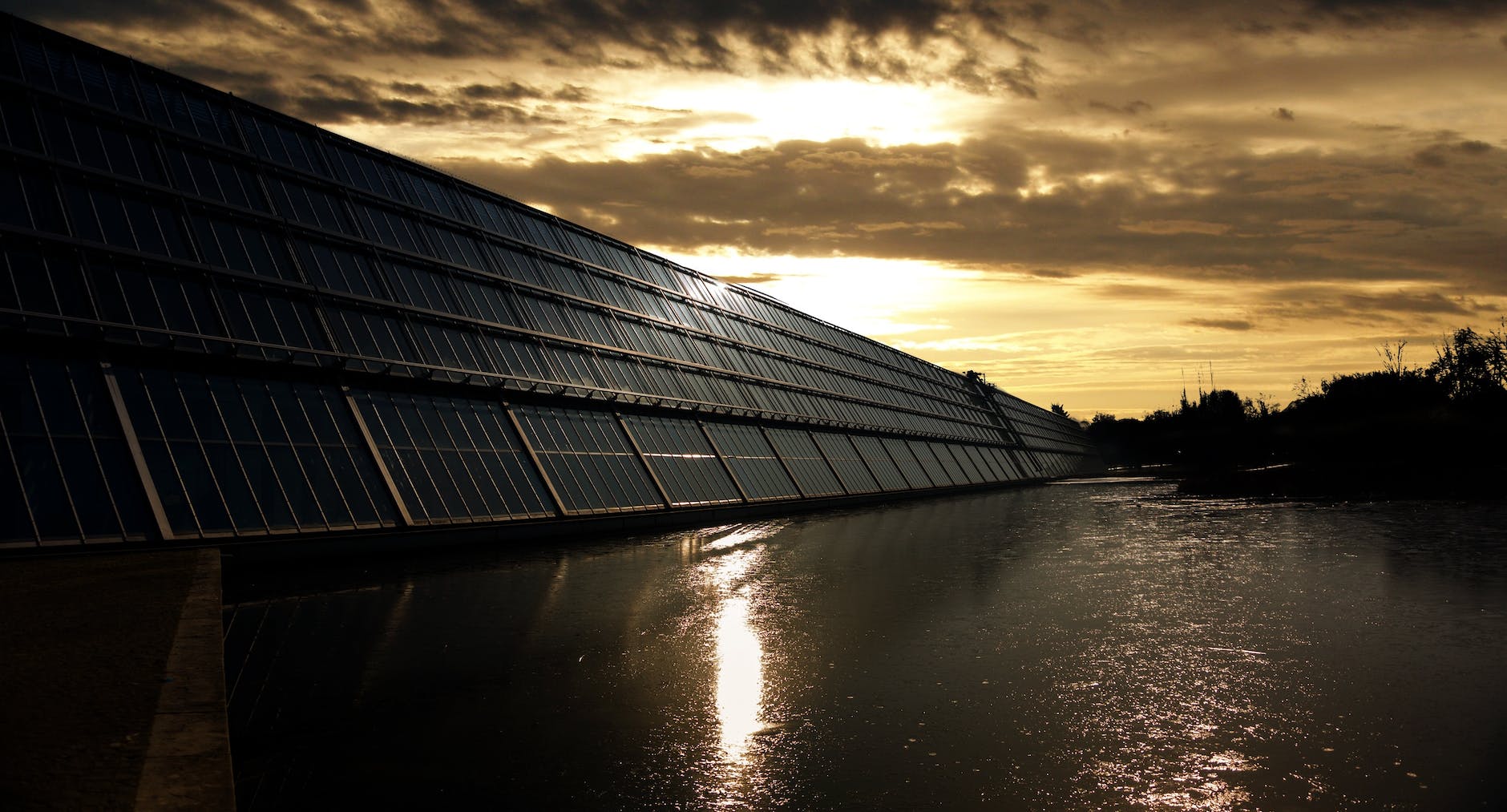 black solar panel near calm body of water