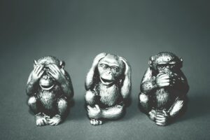 grayscale photography of three wise monkey figurines