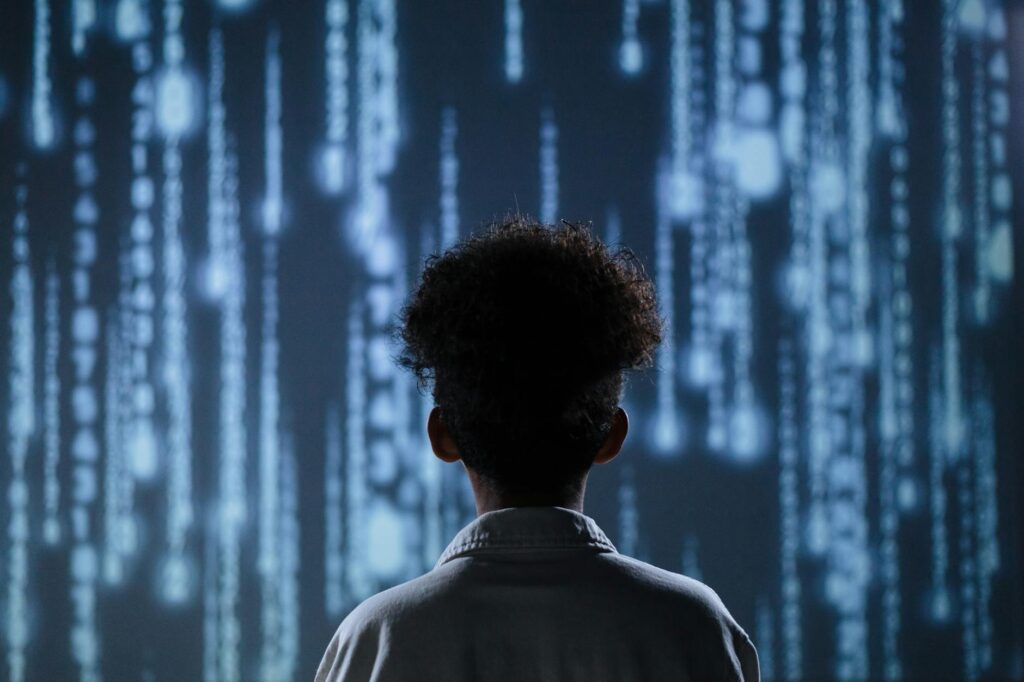 back view of a teen boy with a digital background
