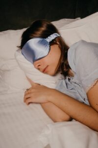 asleep woman wearing eye sleeping mask
